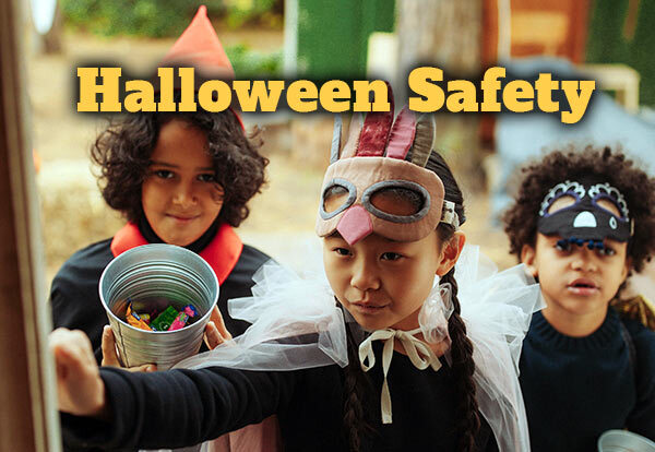 Three kids dressed up in Halloween costumes knocking on a door.