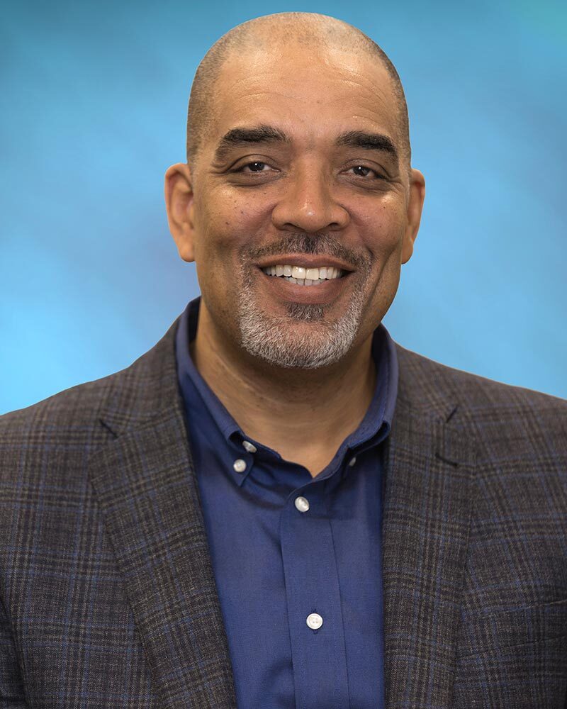 Derrick Montgomery smiles for his headshot.