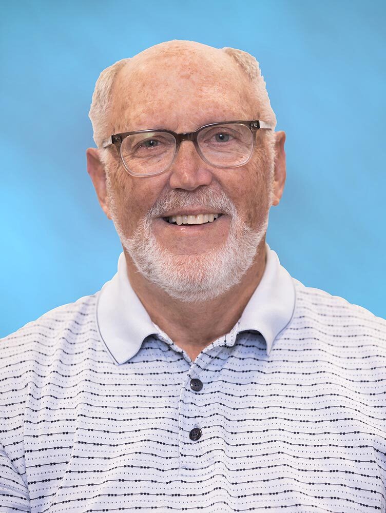 Don Capshaw smiles excitedly for his headshot.