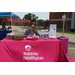 A woman sitting behind a table that reads &quot;superior health plan&quot;