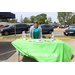 A woman standing behind a table that reads &quot;Cigna HealthSpring&quot;