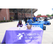 A woman sitting behind a table that reads &quot;Christus St. Michael Health System&quot;
