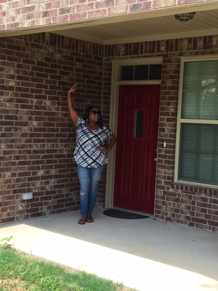 View of a woman standing in the front of a house