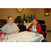 2 women with papers at table