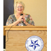 Woman speaking behind a podium