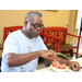 A man giving a funny face to the camera while eating watermelon