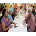 group of residents eating watermelon at a table