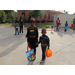 Two children dressed in Halloween costumes holding hands
