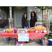 Two women standing at a table with candy