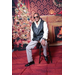 male posing in front of holiday backdrop with fireplace and Christmas tree