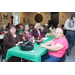 4 residents sitting at a table with drinks