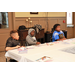 three children coloring at table together