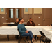 three women sitting at table listening to speaker