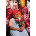 lady holding flowers in front of heart balloons