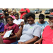 Seated visitors smiling for camera