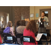 Woman speaking to seated guests