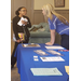 Student speaking to woman at info table