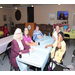 5 attendees sitting around table at event