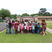 A group of children posing with Miss. Texas