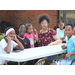 Group of children smiling at a table