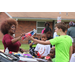 Women handing a prize to a boy