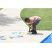 A boy playing with toys on a sidewalk