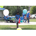 A boy standing behind balloons