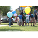 Children standing behind balloons