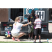 A woman helping two boys