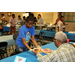 Young boy serving a plate of food to an older man