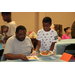 a young boy serving a man food