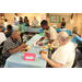 Young child serving two men food