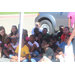 A group of children sitting down underneath a canopy