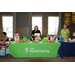 Individuals behind a table that reads &quot;Cigna Health Spring&quot;