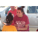 Two women interacting with a young girl