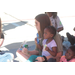 A girl sitting on another girls lap with snacks