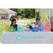 Two girls sitting at a table that reads &quot;Taylor Dental&quot;