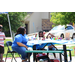 A woman and a child sitting outside at a table