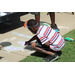 a child drawing on the sidewalk with chalk