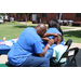 a man painting a boys face outside