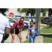 a woman helping a little girl throw sand bags