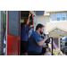 two men speaking into a microphone standing on a truck