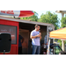 a man standing on a truck speaking to the audience