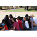 a group of children sitting under a canopy