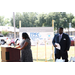 Woman speaking while Mr. Williams stands behind her