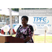 Woman in a dress speaking behind a podium