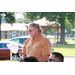 Man in an orange shirt standing up