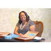 a  woman smiling at a table with tickets