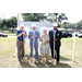 three men and a woman posing with shovels