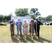 three men and two women posing with shovels